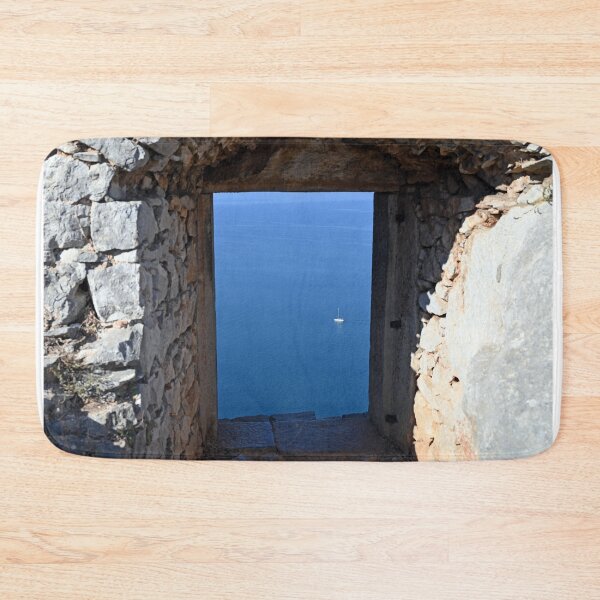 Item preview, View of the sea and sailboat through an old stone window on the Palamidi fortress Nafplio designed and sold by goceris.