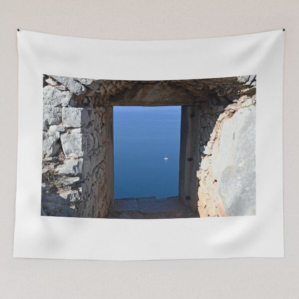 Item preview, View of the sea and sailboat through an old stone window on the Palamidi fortress Nafplio designed and sold by goceris.