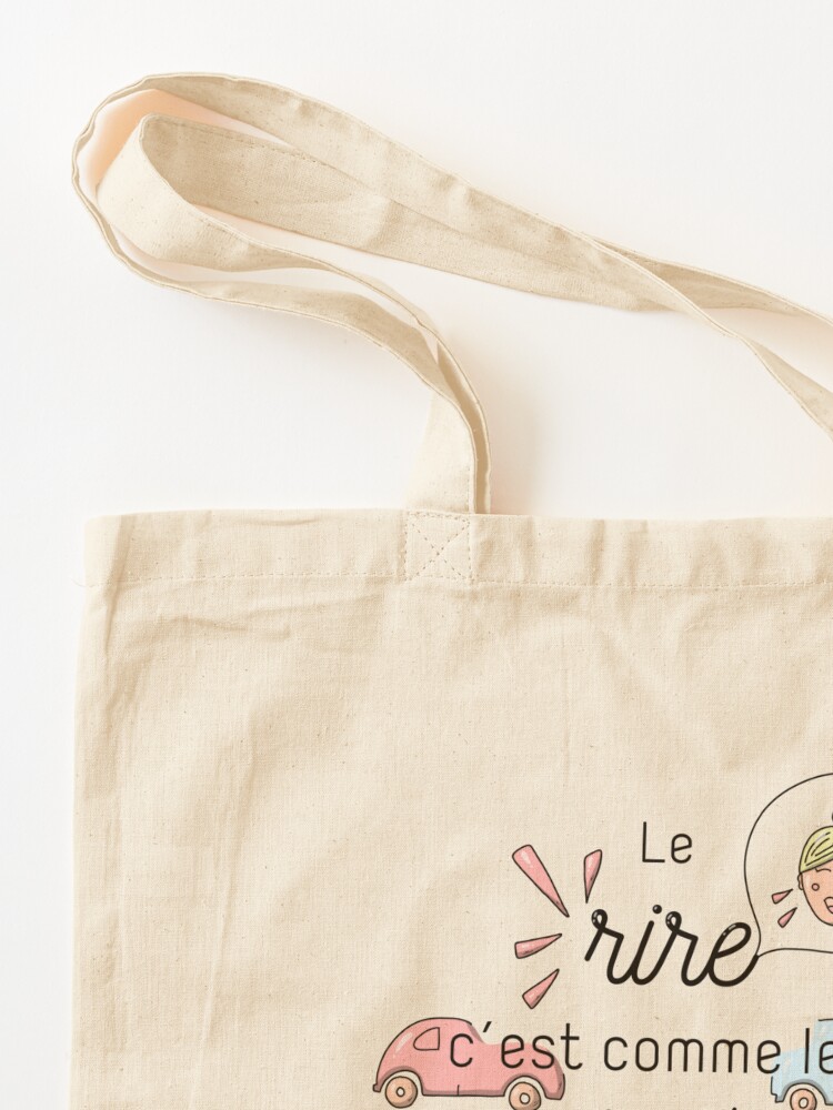 Aperçu 3 sur 5. Tote bag avec l'œuvre Citation : Le rire c'est comme les essuie-glaces créée et vendue par GribouillStreet.