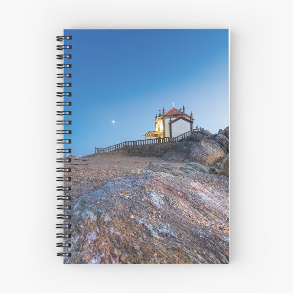 Item preview, Sand and rock view Chapel of the Lord of the Stone with moon in the sky in Portugal  designed and sold by jpferreiraphoto.