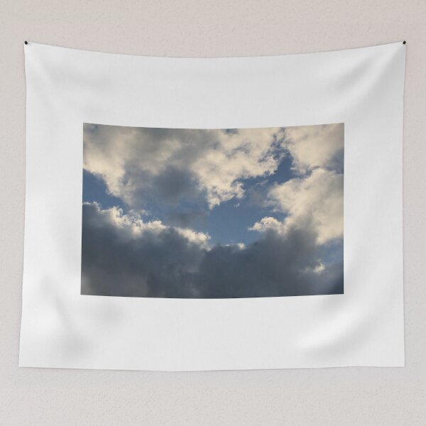 Item preview, Clouds in a blue sky reflecting the orange sun designed and sold by EwanP123.