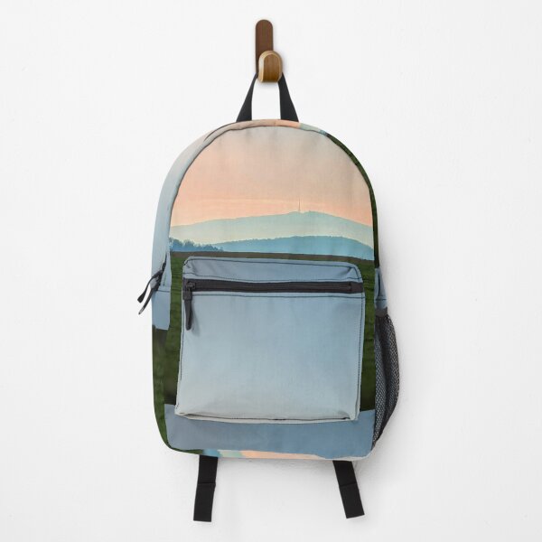 view of the mountain against the backdrop of the setting sun Backpack