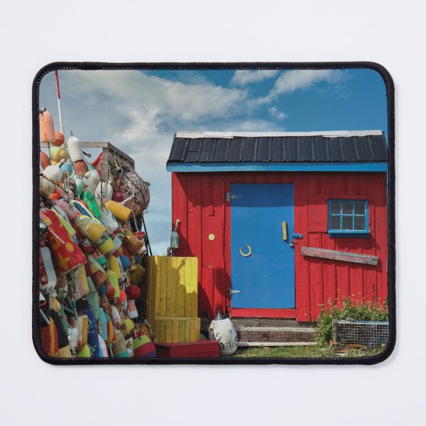 Item preview, The Buoy Shack: Colourful buoys adorn a fence alongside a red and blue shack designed and sold by Amanda White.