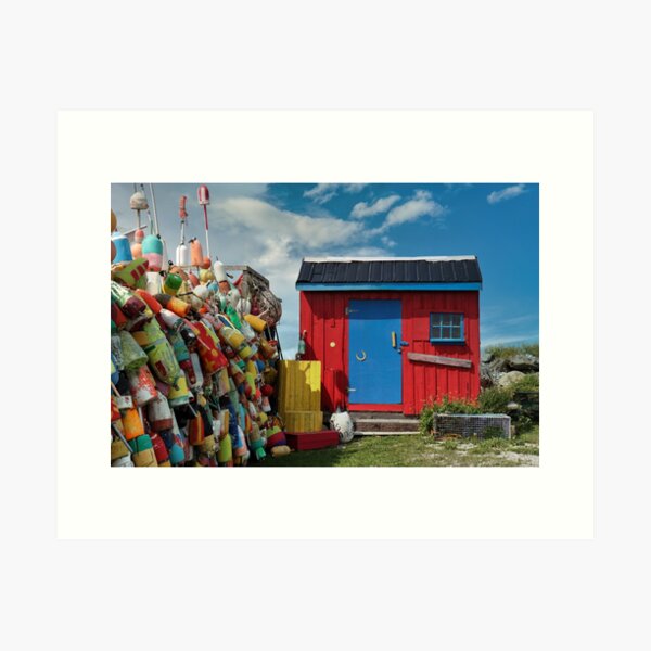 Item preview, The Buoy Shack: Colourful buoys adorn a fence alongside a red and blue shack designed and sold by Amanda White.