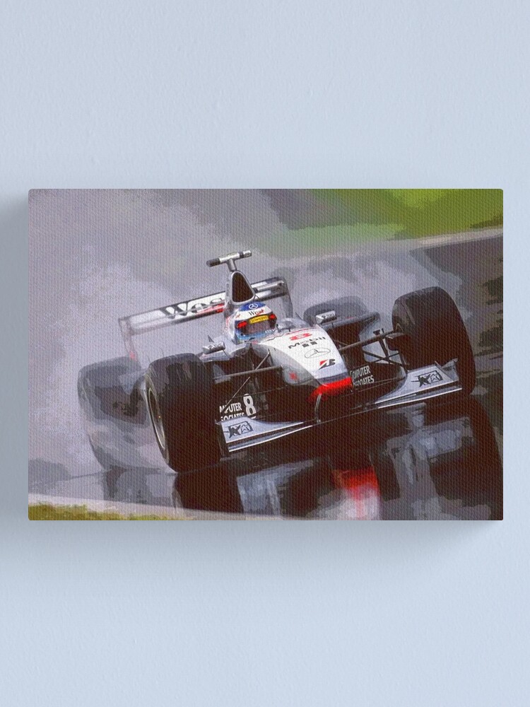 Mika Hakkinen racing his 1998 MP4 13 F1 racecar in the rain