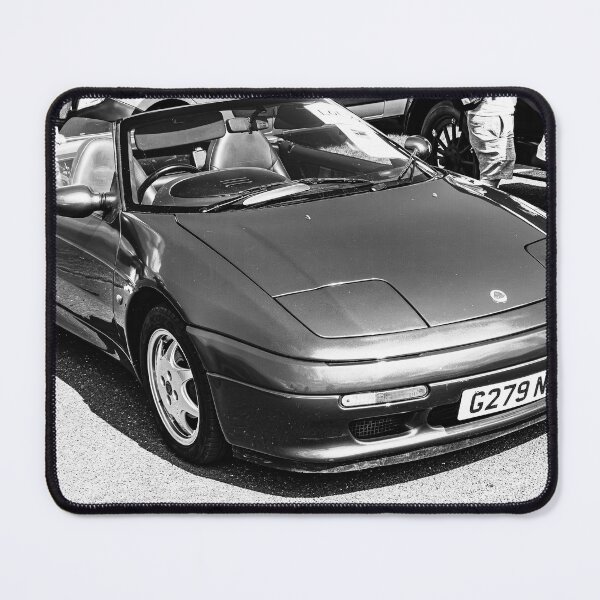 Item preview, Black and white image of the front of a blue Lotus Elan, 1990 on display  designed and sold by Graham Cornall.