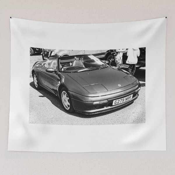 Item preview, Black and white image of the front of a blue Lotus Elan, 1990 on display  designed and sold by Graham Cornall.