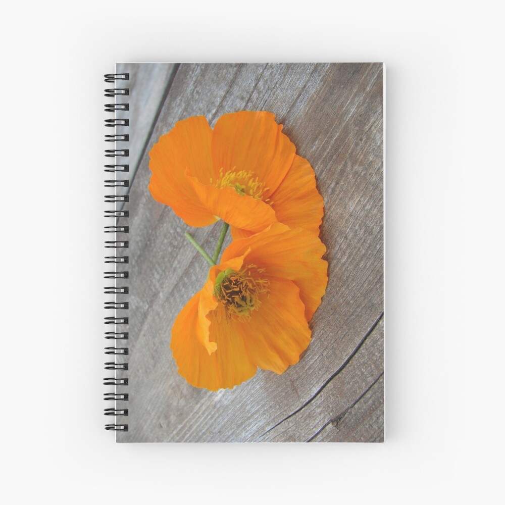 Orange flowers on a wooden table Spiral Notebook