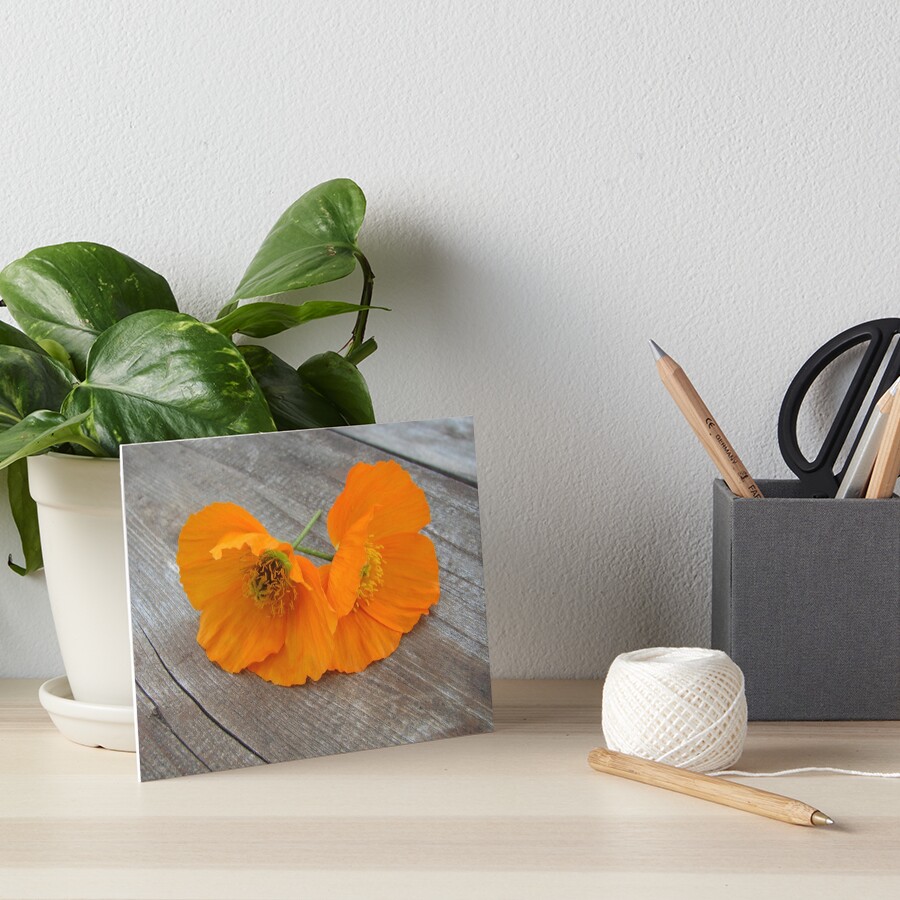 Orange flowers on a wooden table Art Board Print