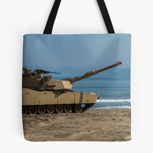 Item preview, STK109839M-U.S. Army Soldier guides an M1A1 Abrams Main Battle Tank on the beach. designed and sold by StocktrekImages.