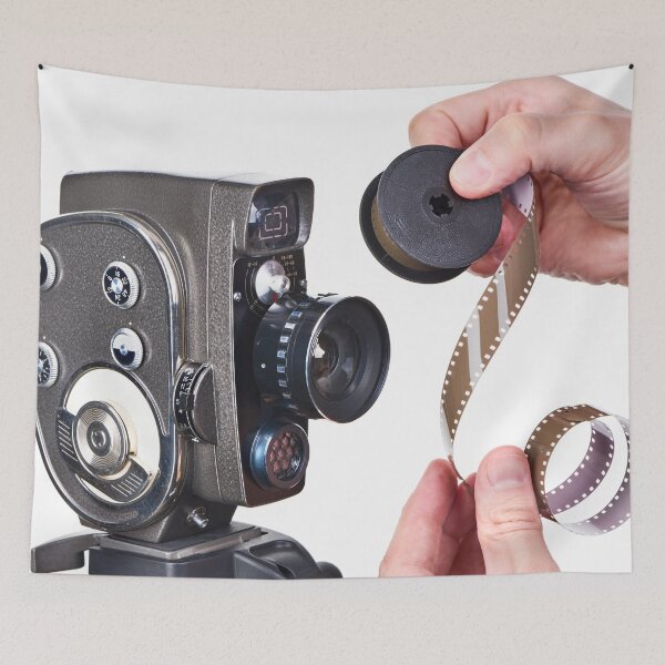 Item preview, Retro movie camera and film in hands designed and sold by Ryzhov.