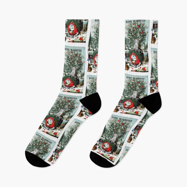 Item preview, Born in winter: winter landscape of a conifer decorated with red and white balls with a white cat perched high up. Inscription: Born in winter at the top of the image and Careful people at the bottom designed and sold by Creativesphotos.