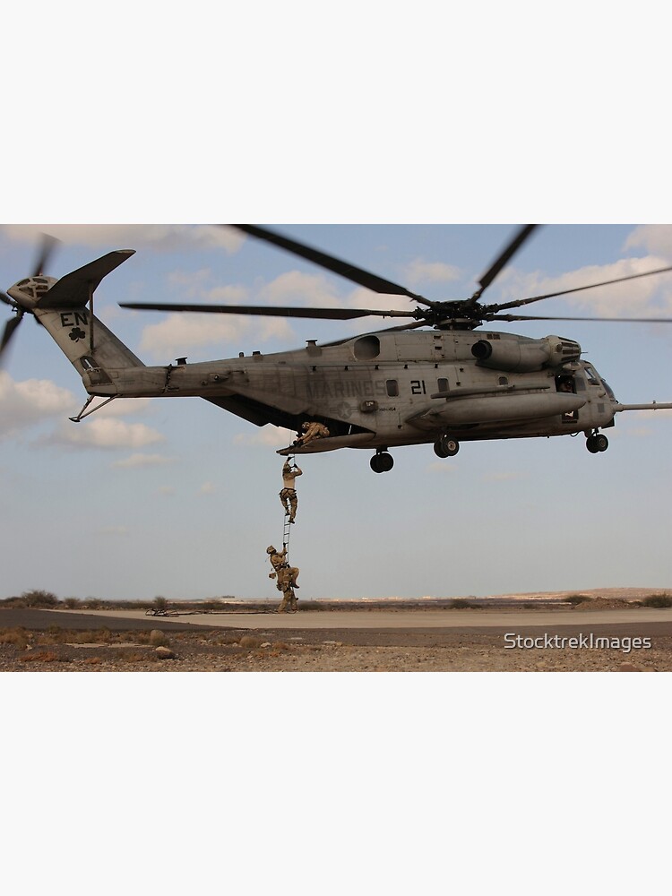 STK109523M-Pararescuemen disembark from a CH-53 Super Stallion