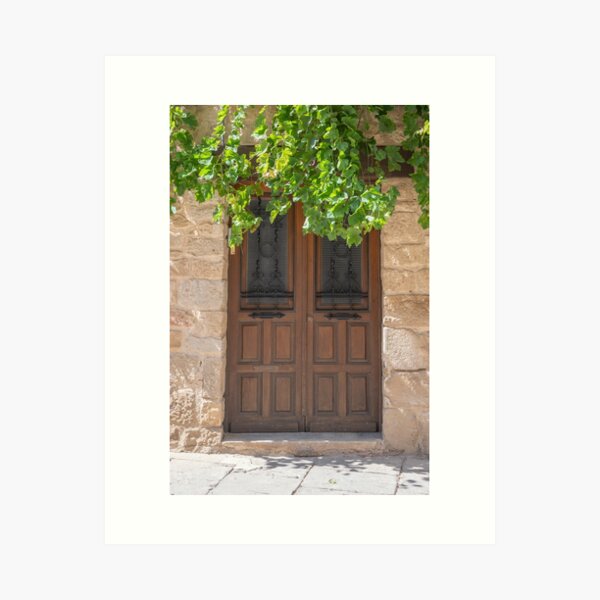 Item preview, The brown door with the grapes in Spain art print - summer street and travel photography designed and sold by Christa Stroo.