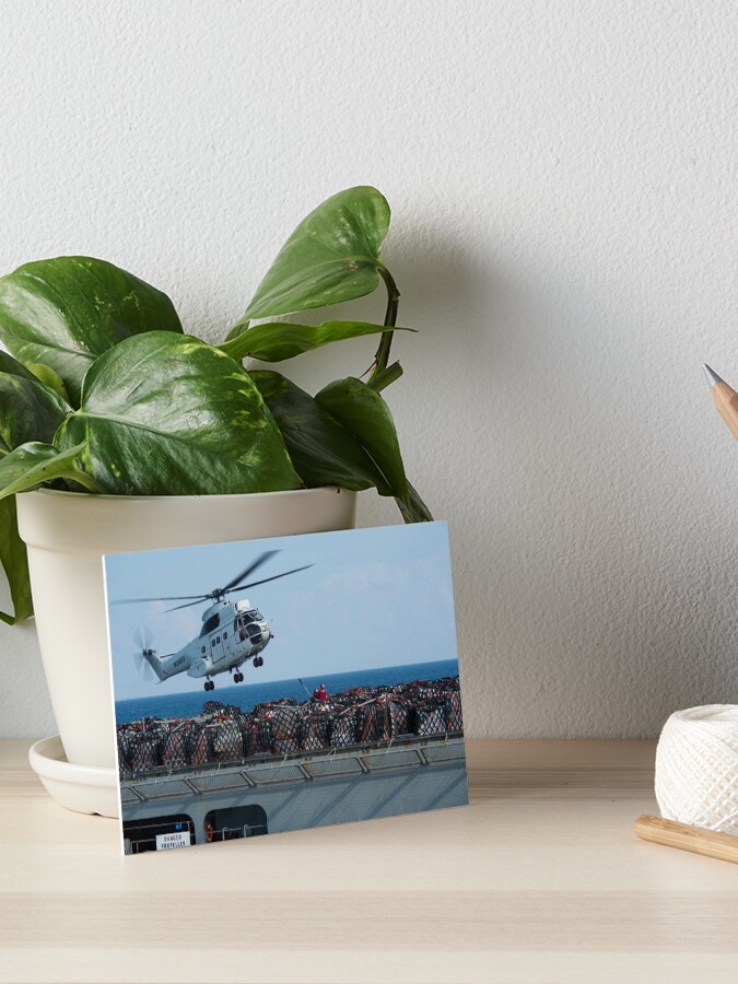 STK109161M-Cargo is being attached to an AS-332 Super Puma Art  Board Print