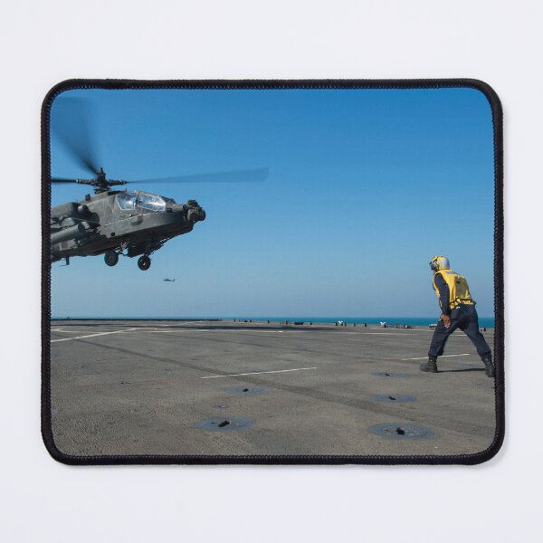Item preview, STK109149M-Boatswain's Mate signals an Apache helicopter on the flight deck of USS Comstock. designed and sold by StocktrekImages.
