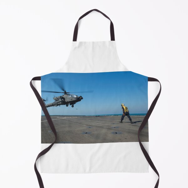 Item preview, STK109149M-Boatswain's Mate signals an Apache helicopter on the flight deck of USS Comstock. designed and sold by StocktrekImages.