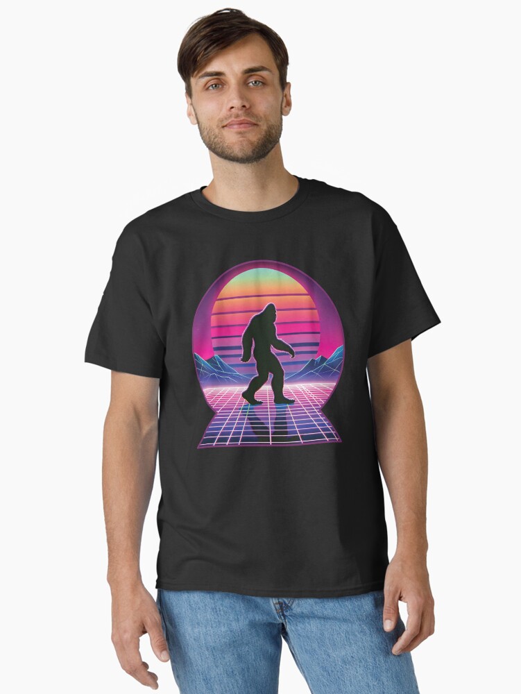 Thumbnail 1 of 7, Classic T-Shirt, Retro Synthwave Bigfoot Silhouette - Neon Sunset Art designed and sold by hidden-design.