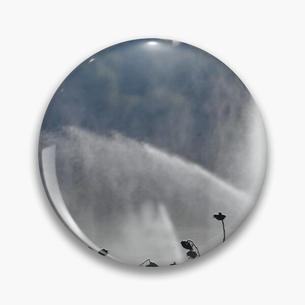 Item preview, Water jets from an irrigation system over a field of dry sunflowers designed and sold by Zosimus.