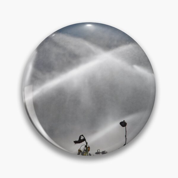 Item preview, Water jets from an irrigation system over a field of dry sunflowers designed and sold by Zosimus.