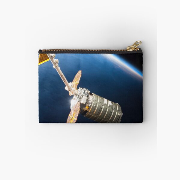 Item preview, STK204994S-Cygnus cargo spacecraft in the grips of the robotic arm above Earth. designed and sold by StocktrekImages.