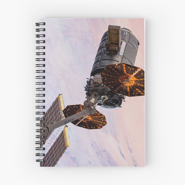 Item preview, STK204999S-Cygnus cargo spacecraft in the grips of the robotic arm above West Africa. designed and sold by StocktrekImages.