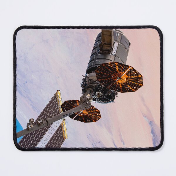 Item preview, STK204999S-Cygnus cargo spacecraft in the grips of the robotic arm above West Africa. designed and sold by StocktrekImages.