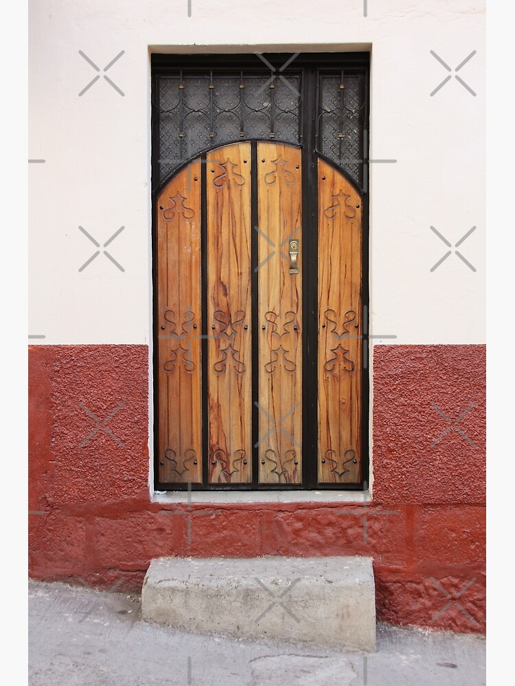 Wood panel door inset in stucco and concrete block stone wall with concrete step on incline by kpander