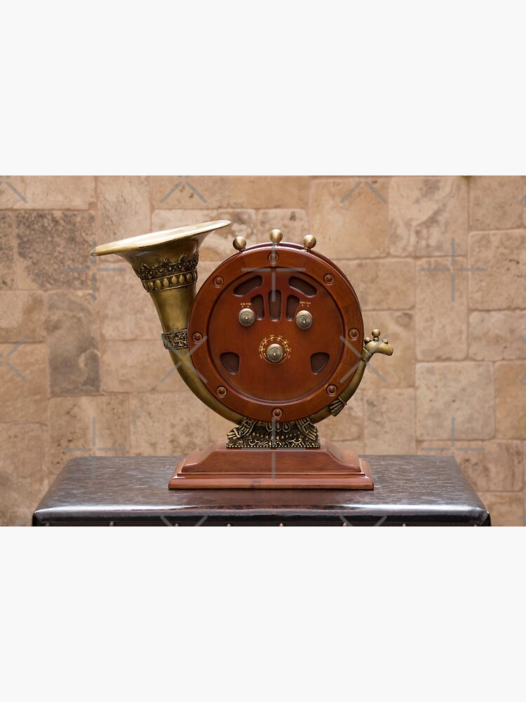 Antique round wood AM/FM radio with brass horn ornate speaker on pedestal on table by kpander