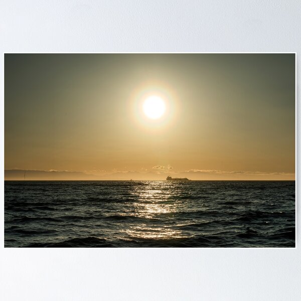 Item preview, Ein einsames Containerschiff auf Hoher See bei goldenem Sonnenuntergang - Foto designed and sold by CineWanderlust.