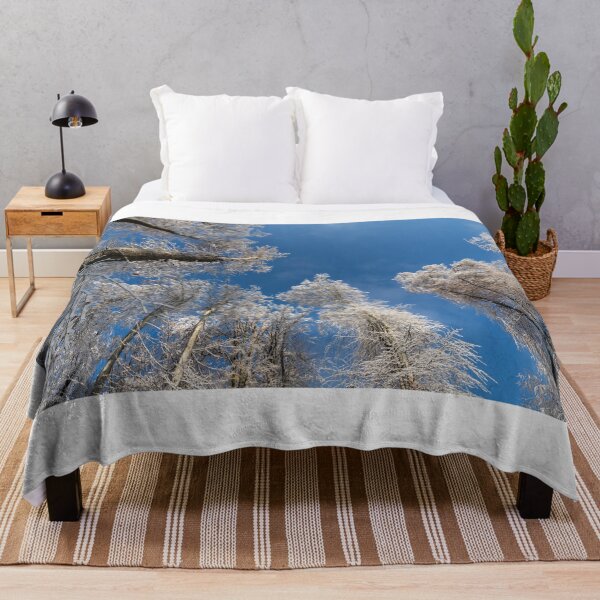 Item preview, Snowy treetops winter forest and blue sky designed and sold by majestix37.