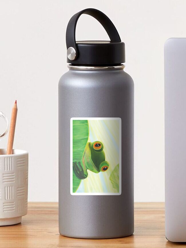Thumbnail 1 of 3, Sticker, Cute Green Frog Peeping out From Behind Lily Pad Illustration designed and sold by ArtJuliaDoria.