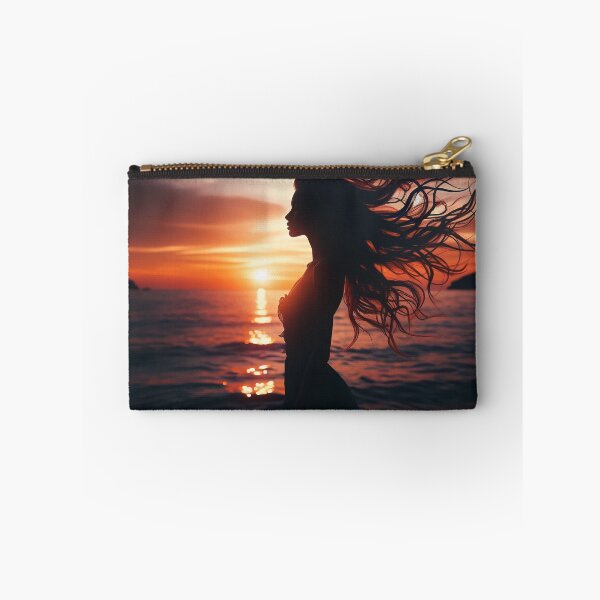 Item preview, Woman standing at the edge of the ocean, her hair flowing with the wind, at sunset designed and sold by AndreaMart.