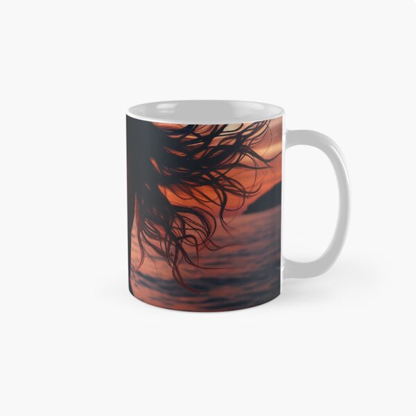 Item preview, Woman standing at the edge of the ocean, her hair flowing with the wind, at sunset designed and sold by AndreaMart.