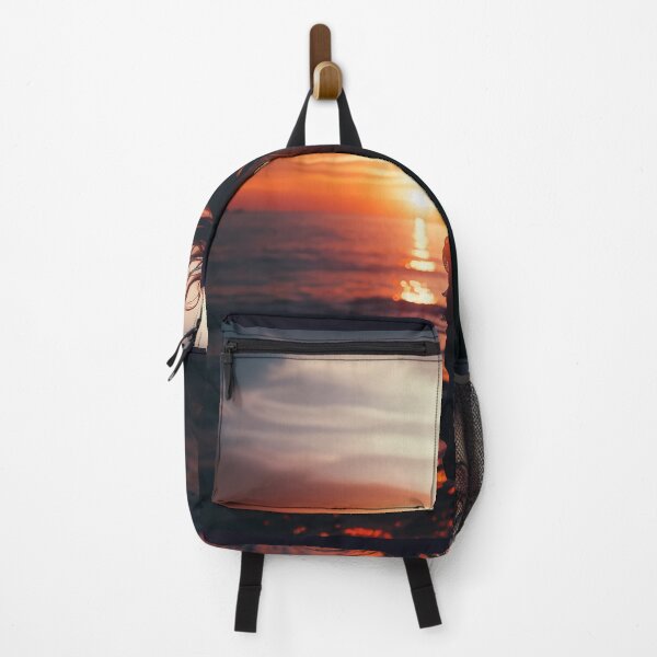 Item preview, Woman standing at the edge of the ocean, her hair flowing with the wind, at sunset designed and sold by AndreaMart.