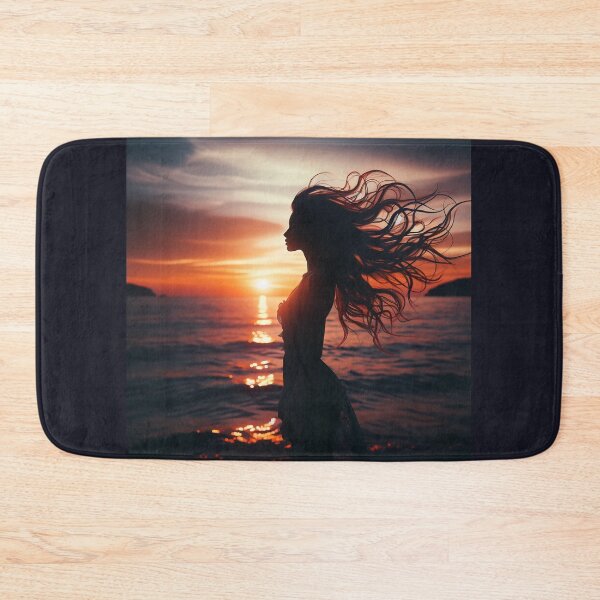 Item preview, Woman standing at the edge of the ocean, her hair flowing with the wind, at sunset designed and sold by AndreaMart.