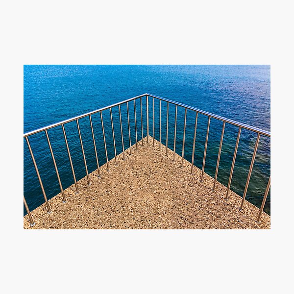 Geometric triangular balcony railings over deep blue lake water Photographic Print