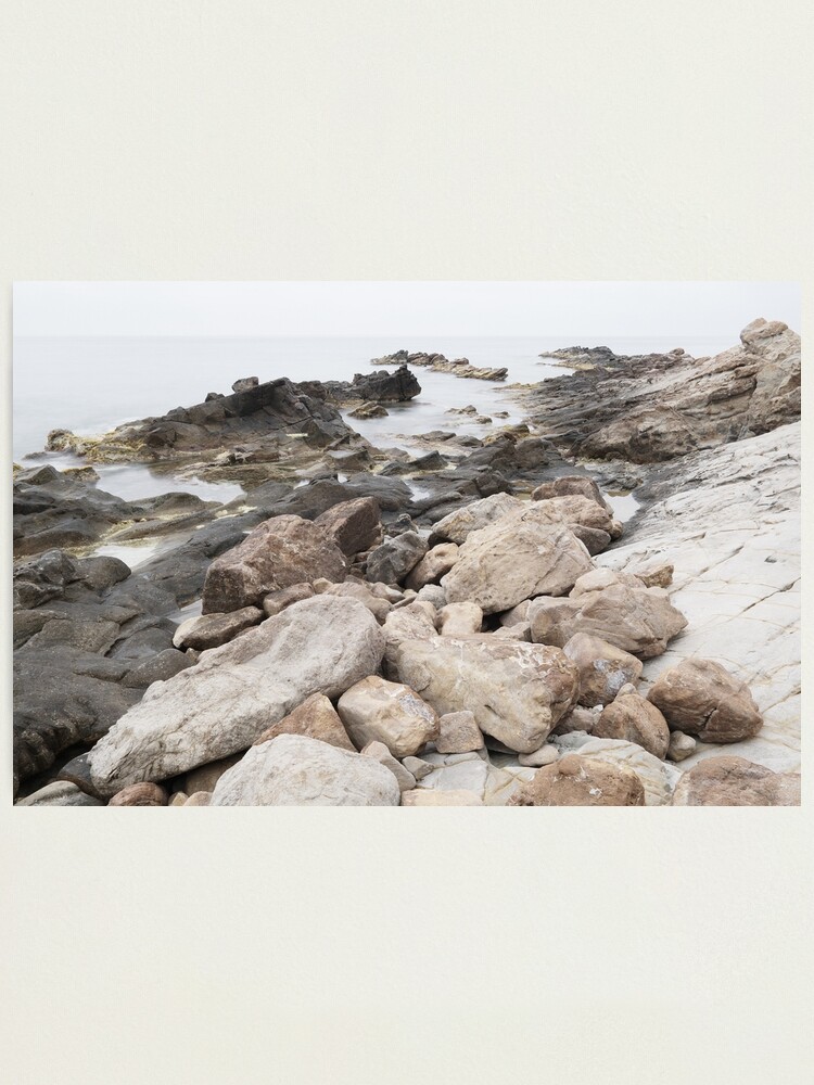 Thumbnail 1 of 3, Photographic Print, Some rocks on the beach designed and sold by patmo.