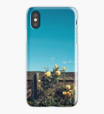 Yellow flowers over a wooden fence iPhone Case/Skin