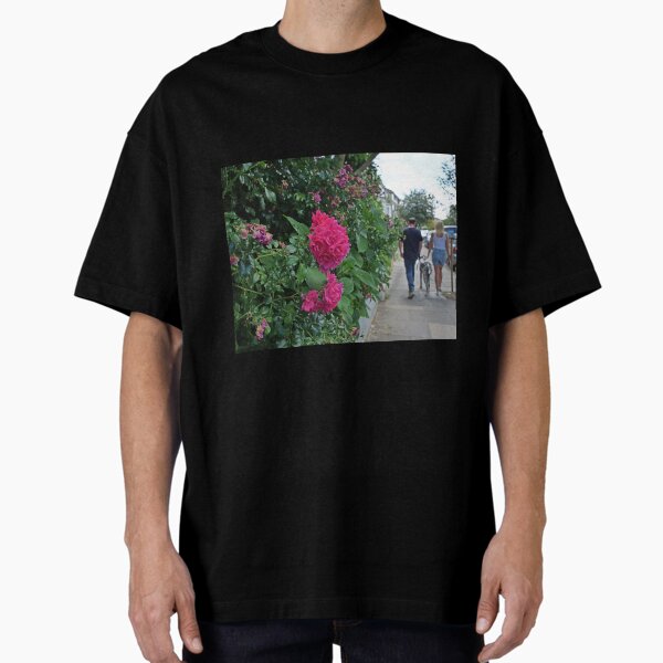 Couple walking the dog in London. Flower bokeh. Oversized T-Shirt