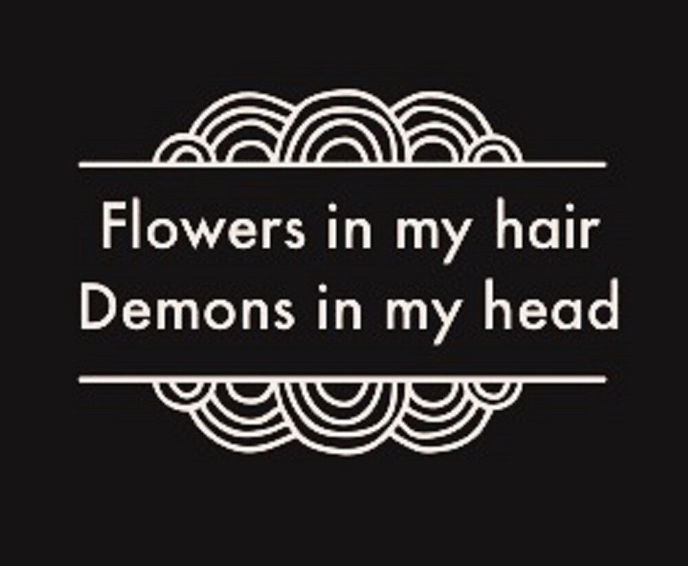 "Flowers in my hair, demons in my head" by Dreamily Redbubble