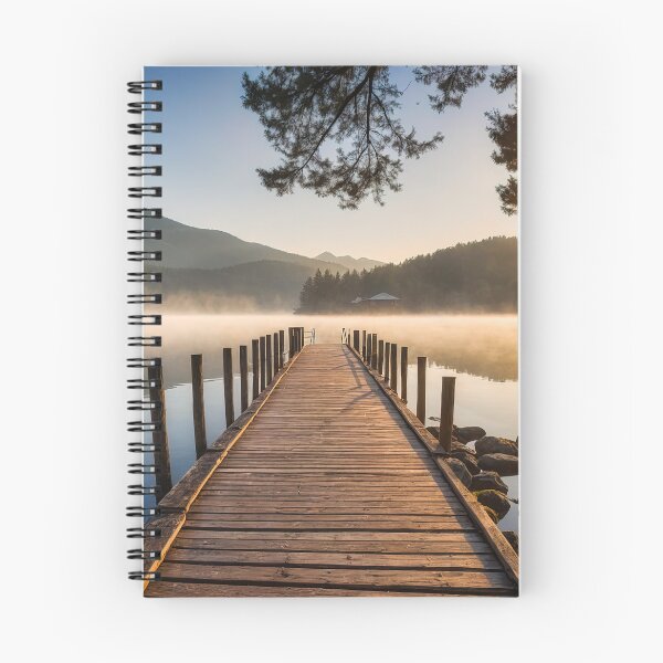 Item preview, Beautiful landscape with mountain peaks next to a lake, a long pier in the water. Sunset colors.  designed and sold by digoarpi.