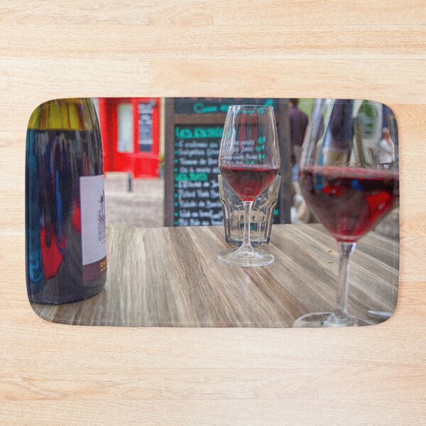 Item preview, Two glasses of red wine and a bottle on a table with  a blurred menu in France designed and sold by Photopat.
