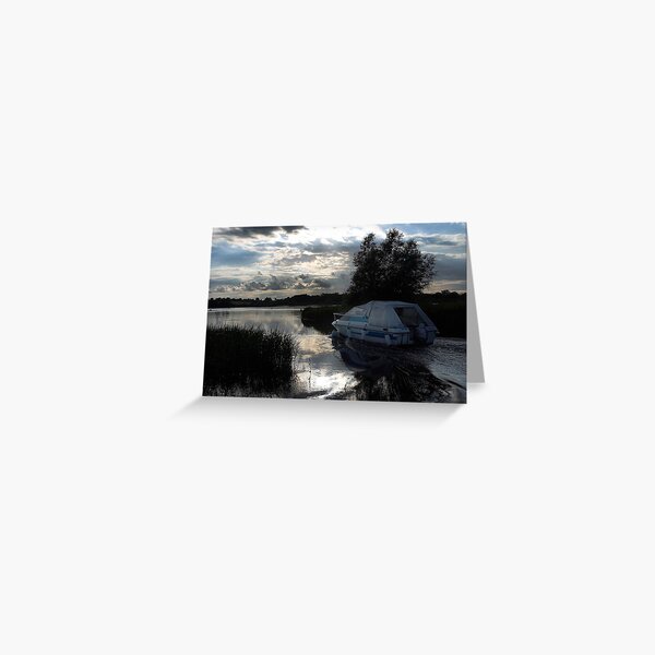 A boat travelling the Norfolk Broads near dusk Greeting Card