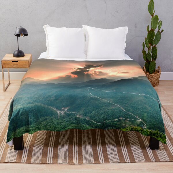 Item preview, Sun Peeking Behind Clouds with light rays shooting across a mountainous valley designed and sold by BloodSweatNTers.