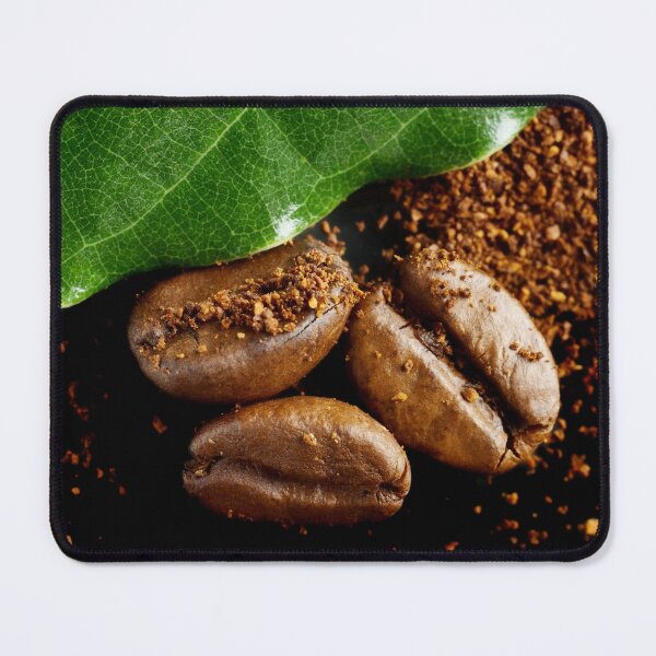 Item preview, Extreme close-up image of coffee beans and ground coffee with green leaf. designed and sold by Vetagio.