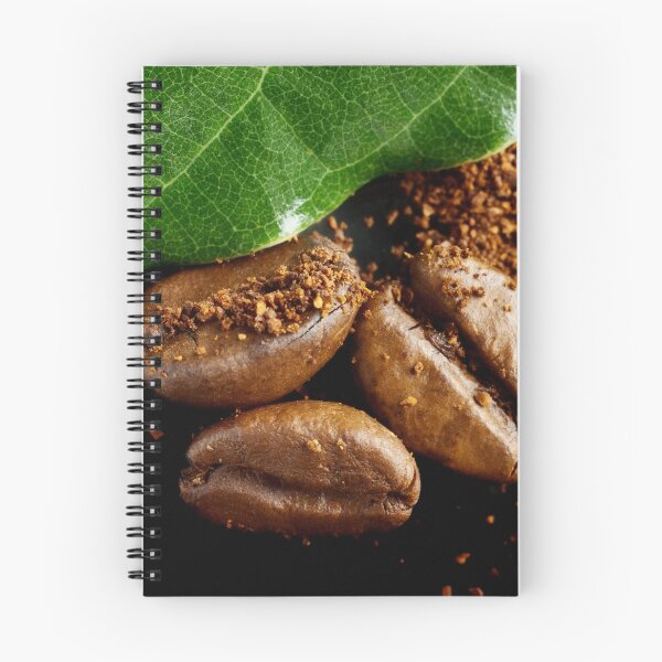 Item preview, Extreme close-up image of coffee beans and ground coffee with green leaf. designed and sold by Vetagio.