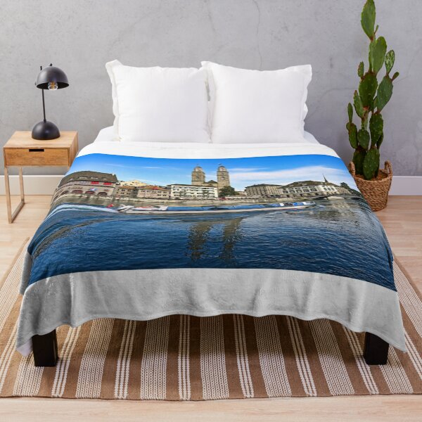 Item preview, Historic Zurich city center with famous Grossmunster churh and a tourist boat sails on the river Limmat, Switzerland designed and sold by goceris.