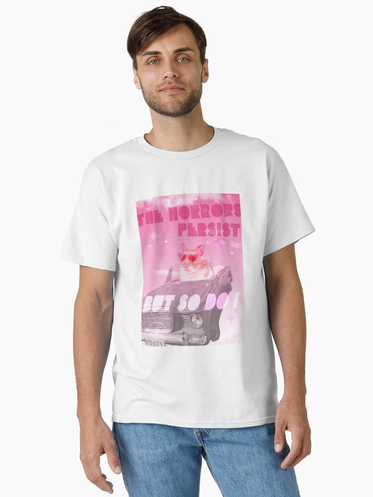 Imagen 1 de 7, Camiseta clásica con la obra Los horrores persisten pero yo también meme hámster., diseñada y vendida por caitlinkdesigns.