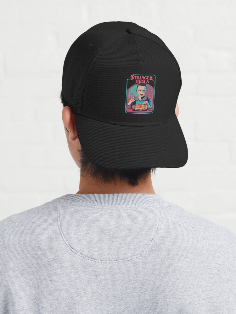 Thumbnail 4 of 7, Cap, STRANGER THINGS, Eleven. Eleven is eating waffles. (black background) designed and sold by bekksa.
